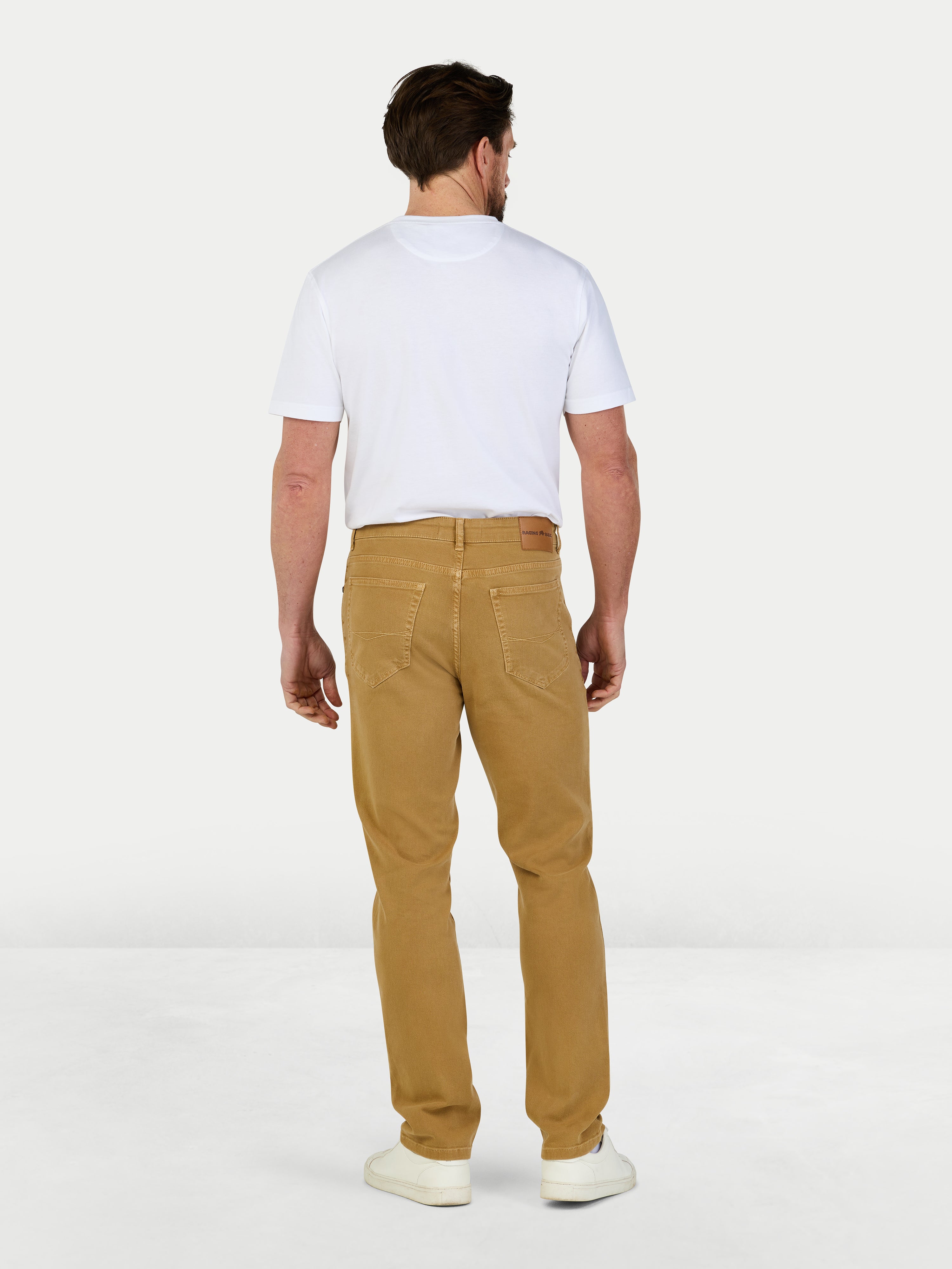 Man wearing a white t-shirt and tan pants on a white background