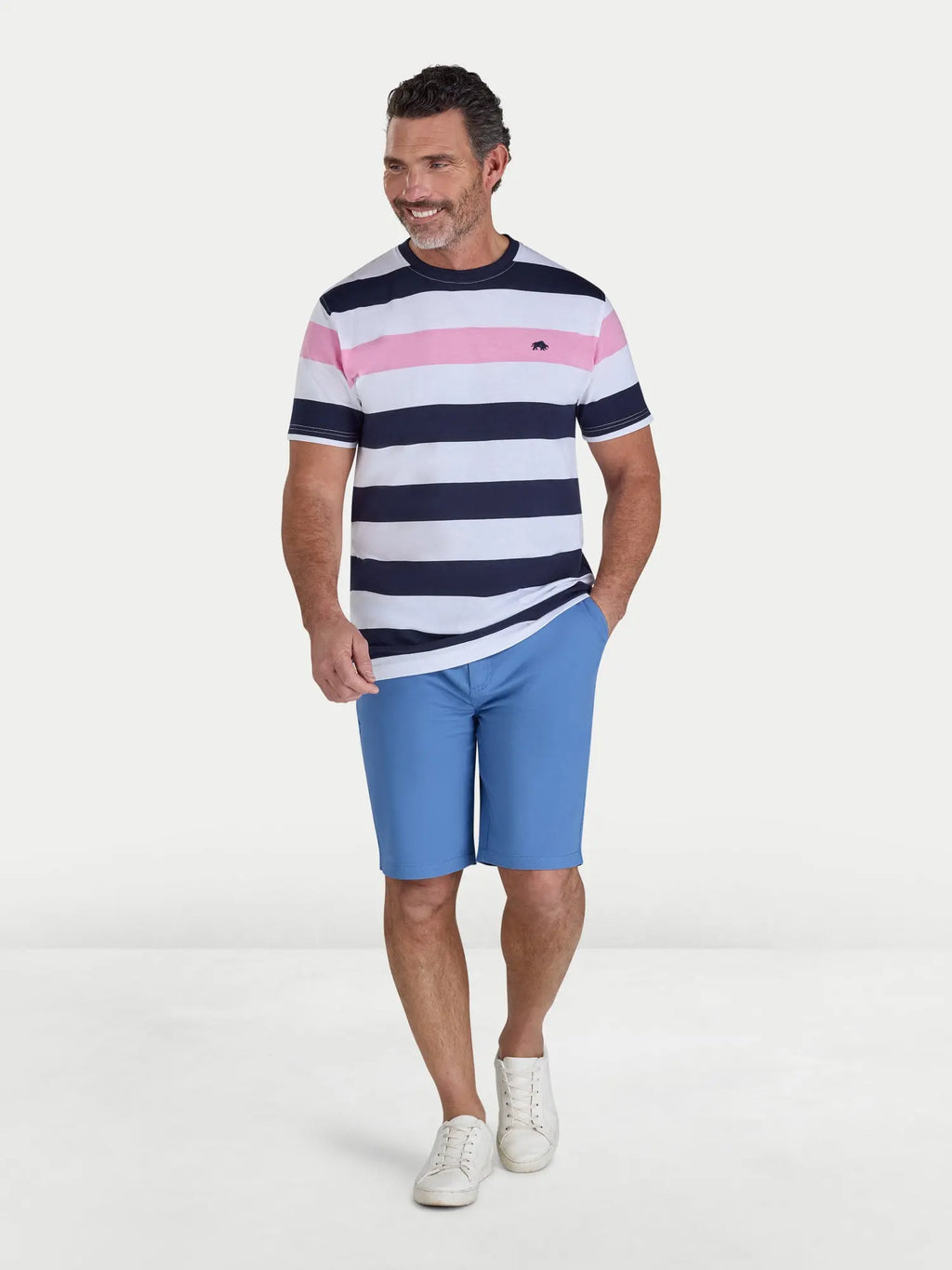 Man wearing a striped shirt and blue shorts on a white background