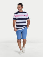 Man wearing a striped shirt and blue shorts on a white background