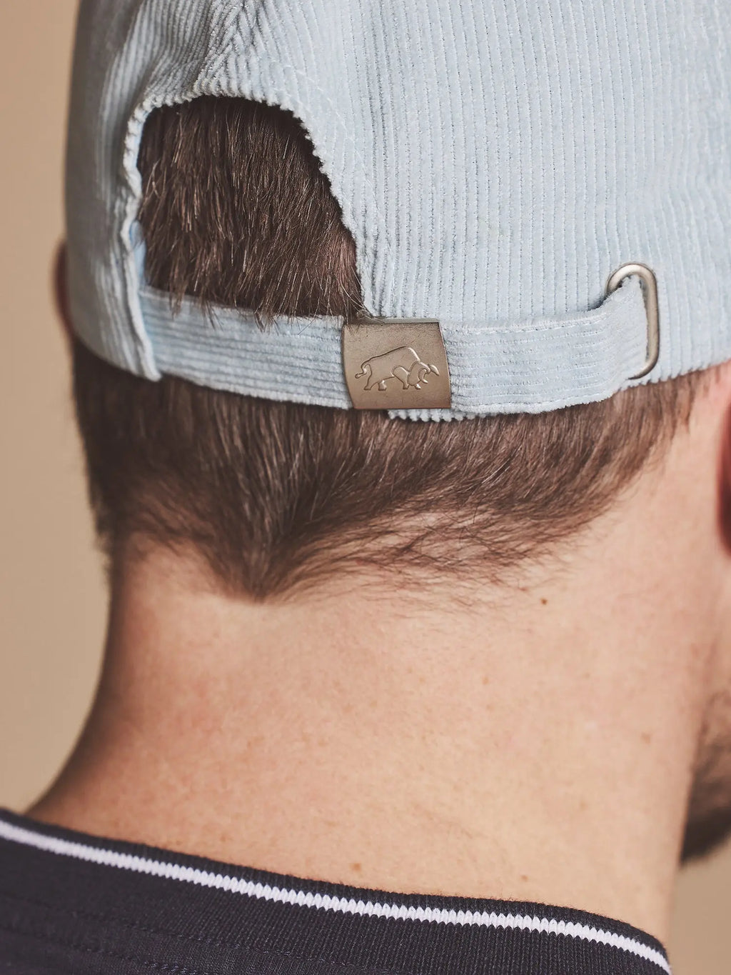 Person wearing a Raging Bull Corduroy cap in blue, back detail. 