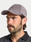 Man wearing a gray baseball cap against a white background