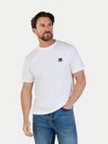 Man wearing a white t-shirt with a small logo on a plain background