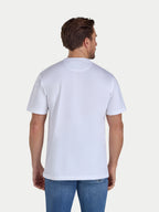 Man wearing a plain white t-shirt on a light gray background