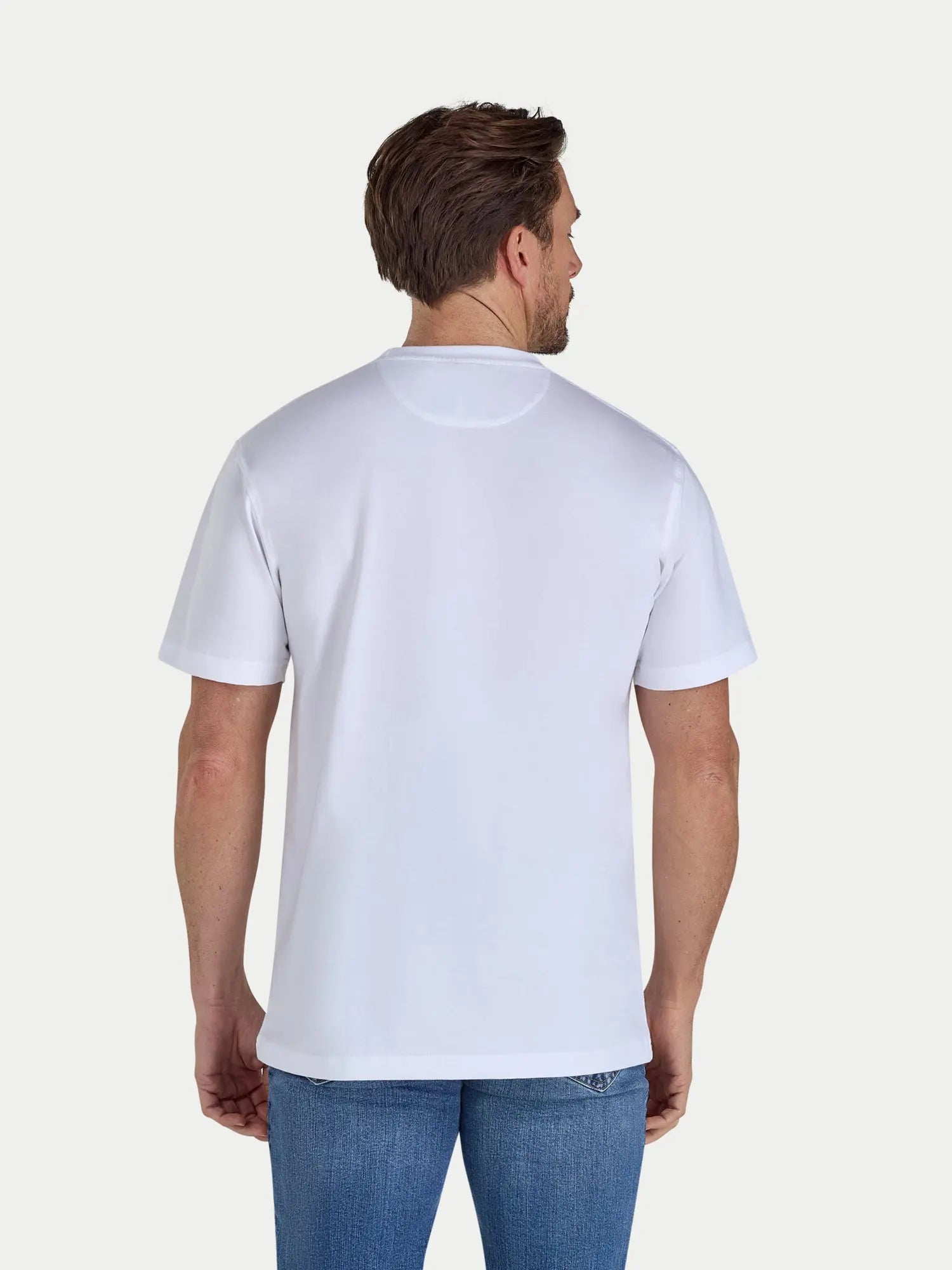 Man wearing a plain white t-shirt on a light gray background