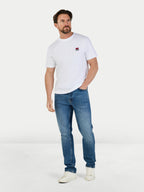 Man wearing a white t-shirt and blue jeans on a white background