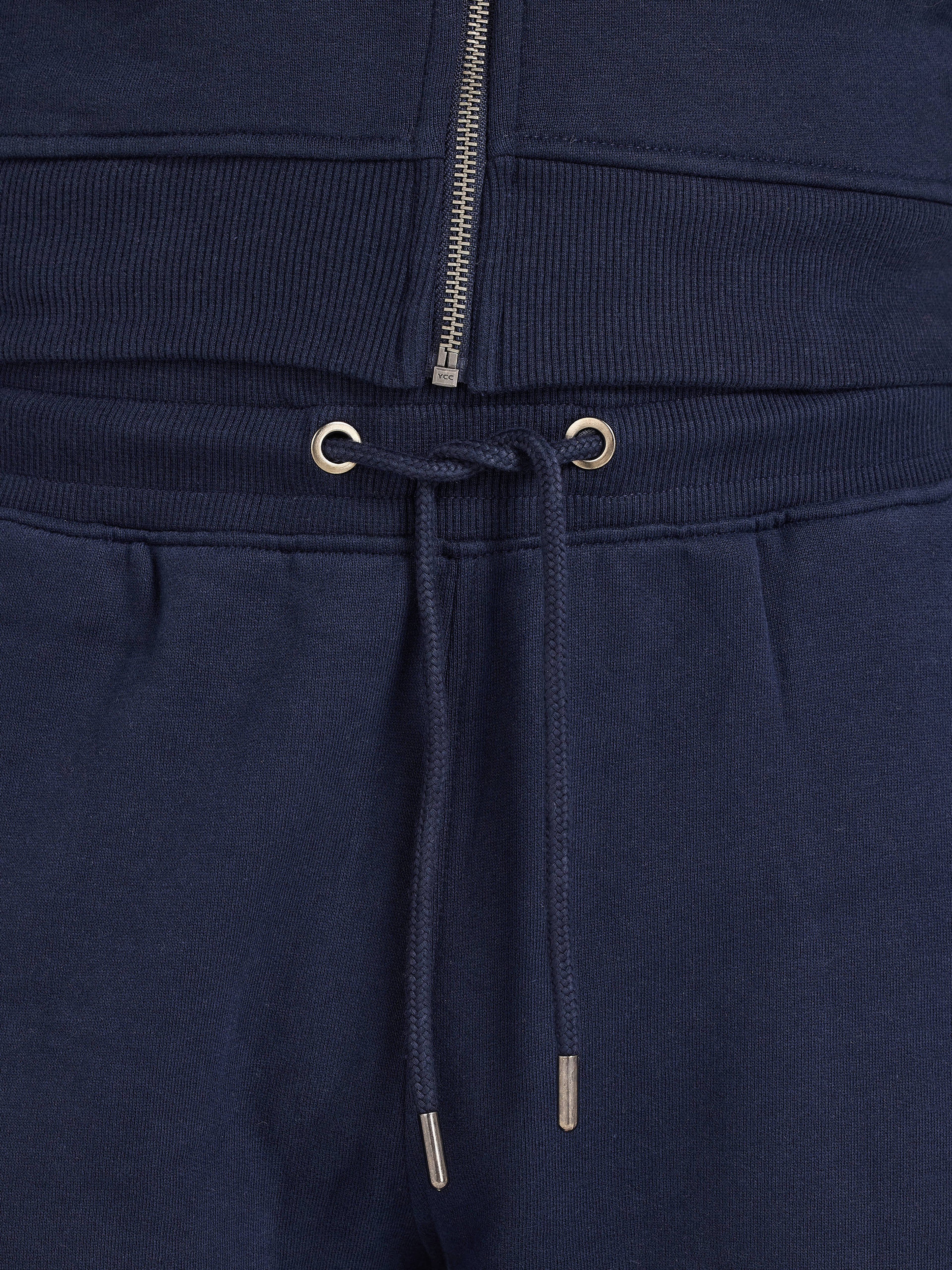 Navy blue sweatpants with drawstring and zipper detail