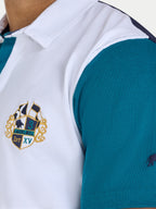 Teal and white polo shirt with a logo on a person wearing it