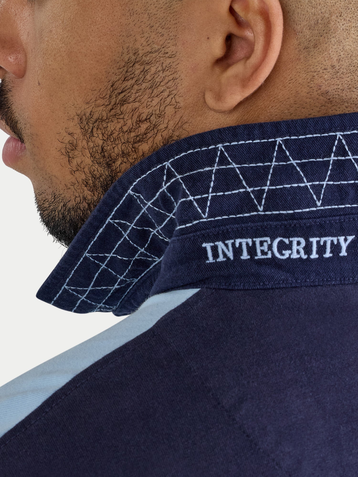 Navy blue shirt with 'INTEGRITY' embroidery on a white background