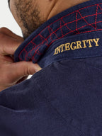 Navy blue shirt with red stitching and 'INTEGRITY' embroidery on a white background