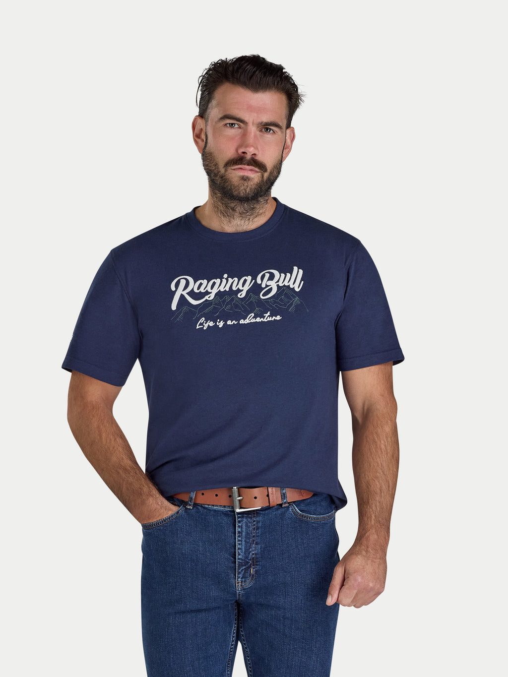 Man wearing a navy blue t-shirt with 'Raging Bull' logo on a white background