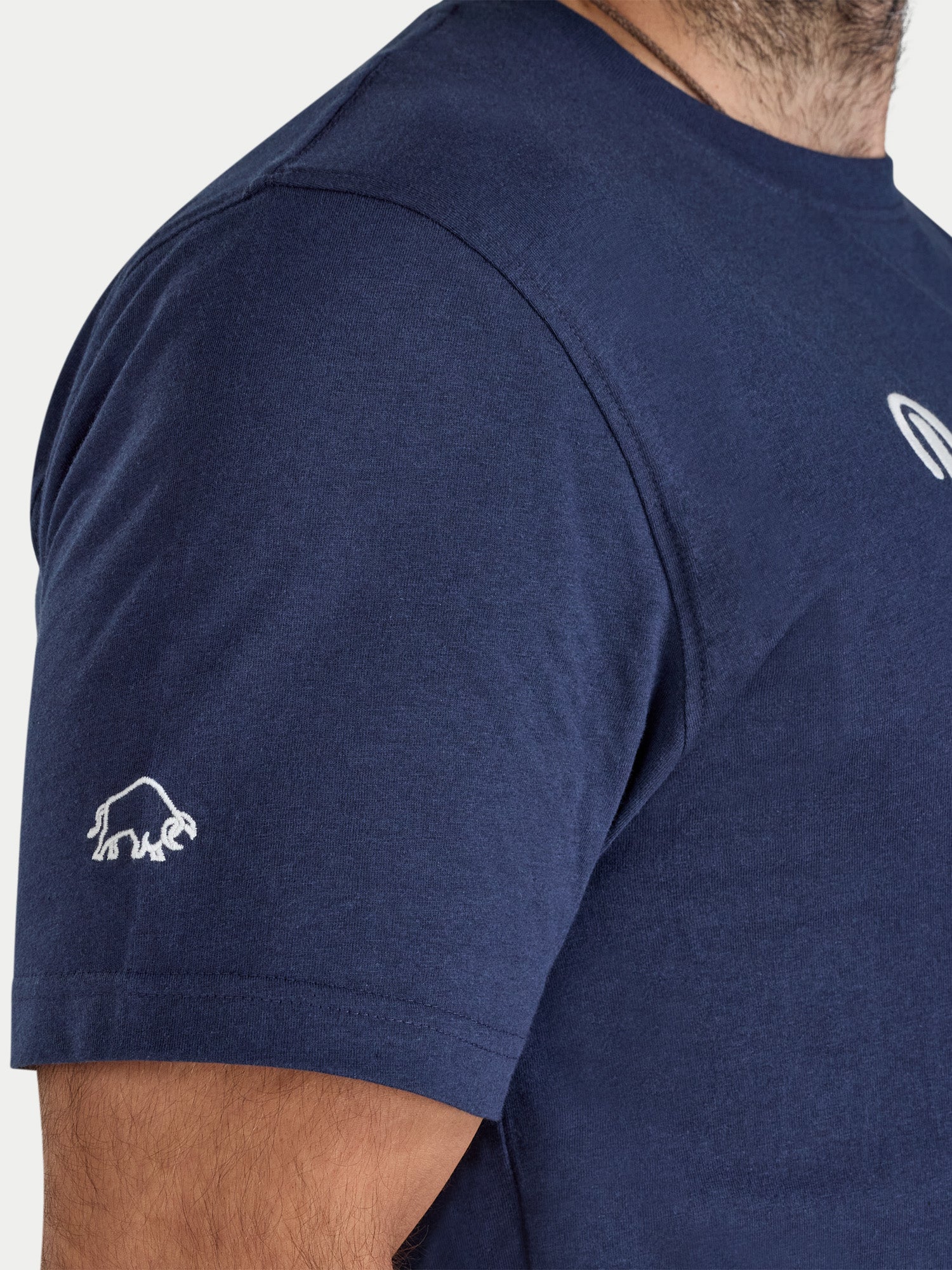Navy blue t-shirt with a logo on the sleeve against a white background