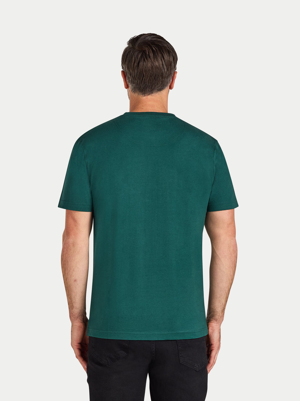 Man wearing a green t-shirt on a white background