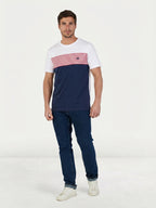Man wearing aRaging Bull Engineered stripe t-shirt in navy, white and red and Regular jeans in denim, front. 