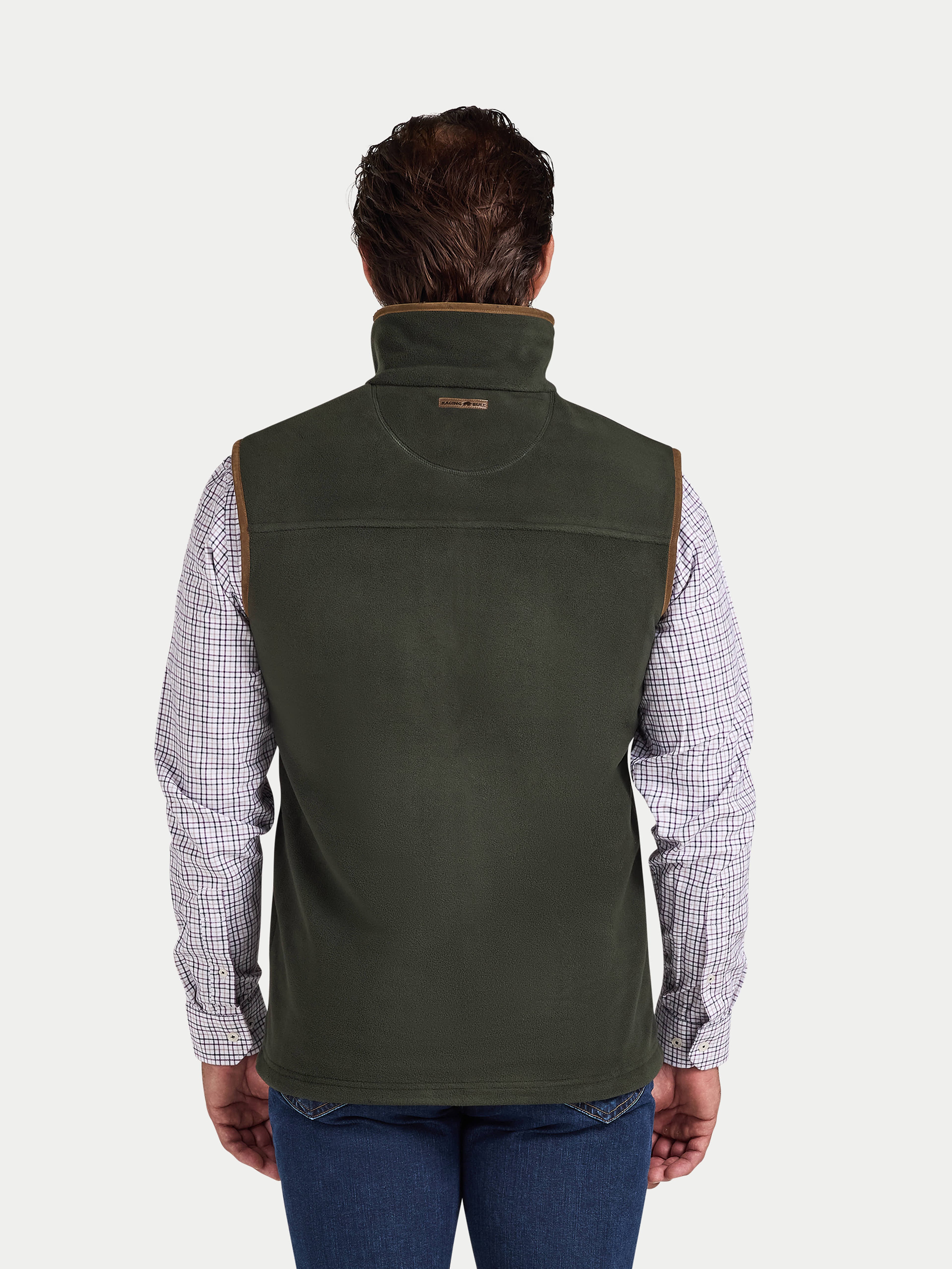Man wearing a green vest over a plaid shirt on a white background
