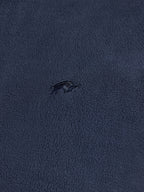 Navy blue fabric texture with a small logo or pattern in the center