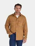 Man wearing a brown shirt with two front pockets on a white background