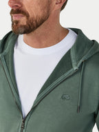 Man wearing a green hoodie with a logo on a white background