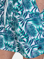 Man wearing Raging Bull Hawaiian Patterned Swim Shorts - Green, pocket detail. 