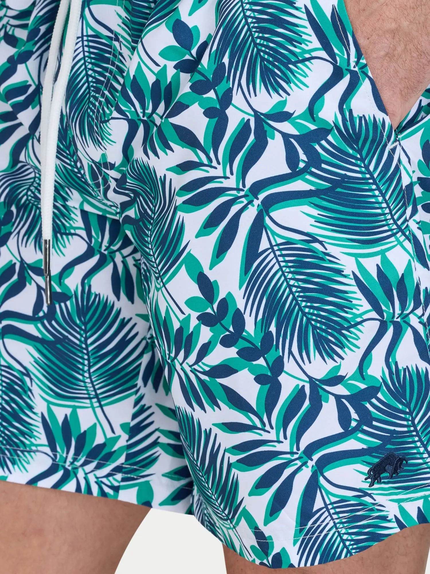 Man wearing Raging Bull Hawaiian Patterned Swim Shorts - Green, pocket detail. 