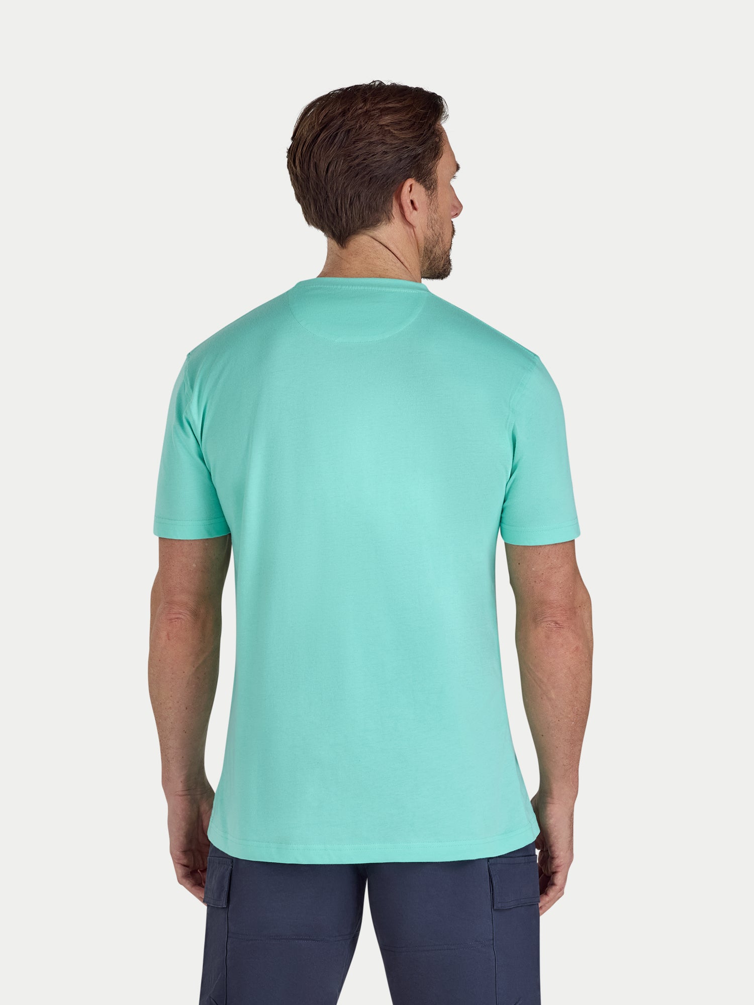 Man wearing a mint green t-shirt on a white background