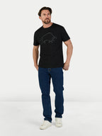 Man wearing a black t-shirt with a graphic design and blue jeans on a white background