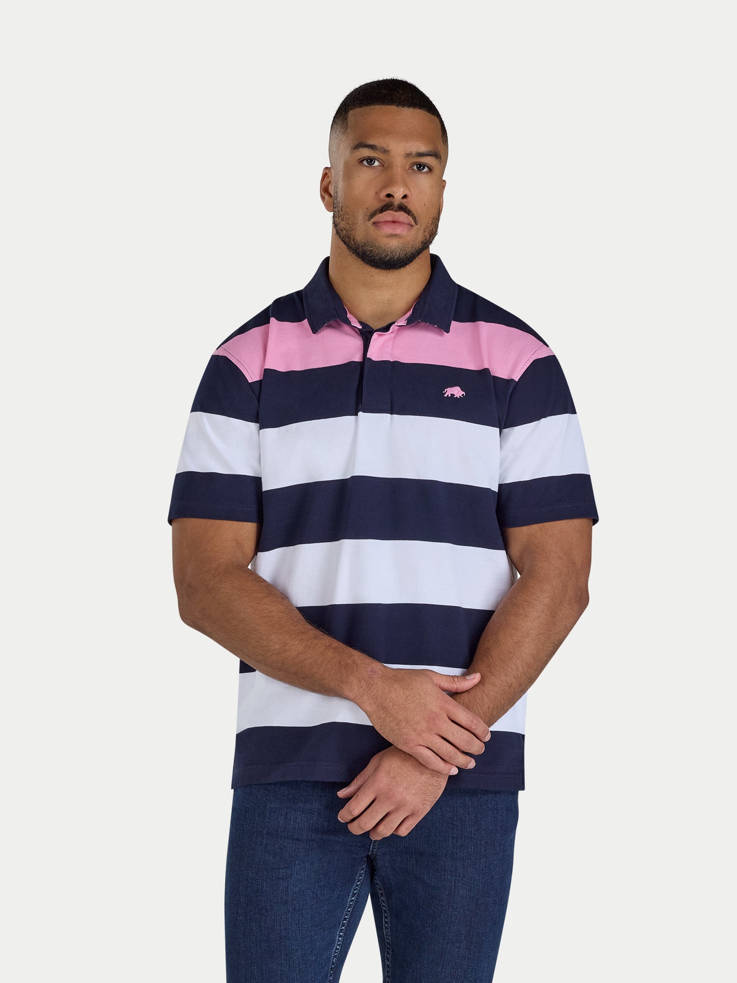 Man wearing a striped polo shirt with a visible Raging Bull logo on a white background