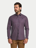 Man wearing a purple patterned shirt on a white background
