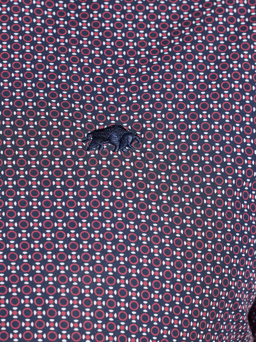Patterned fabric with geometric design in red and blue on a purple background