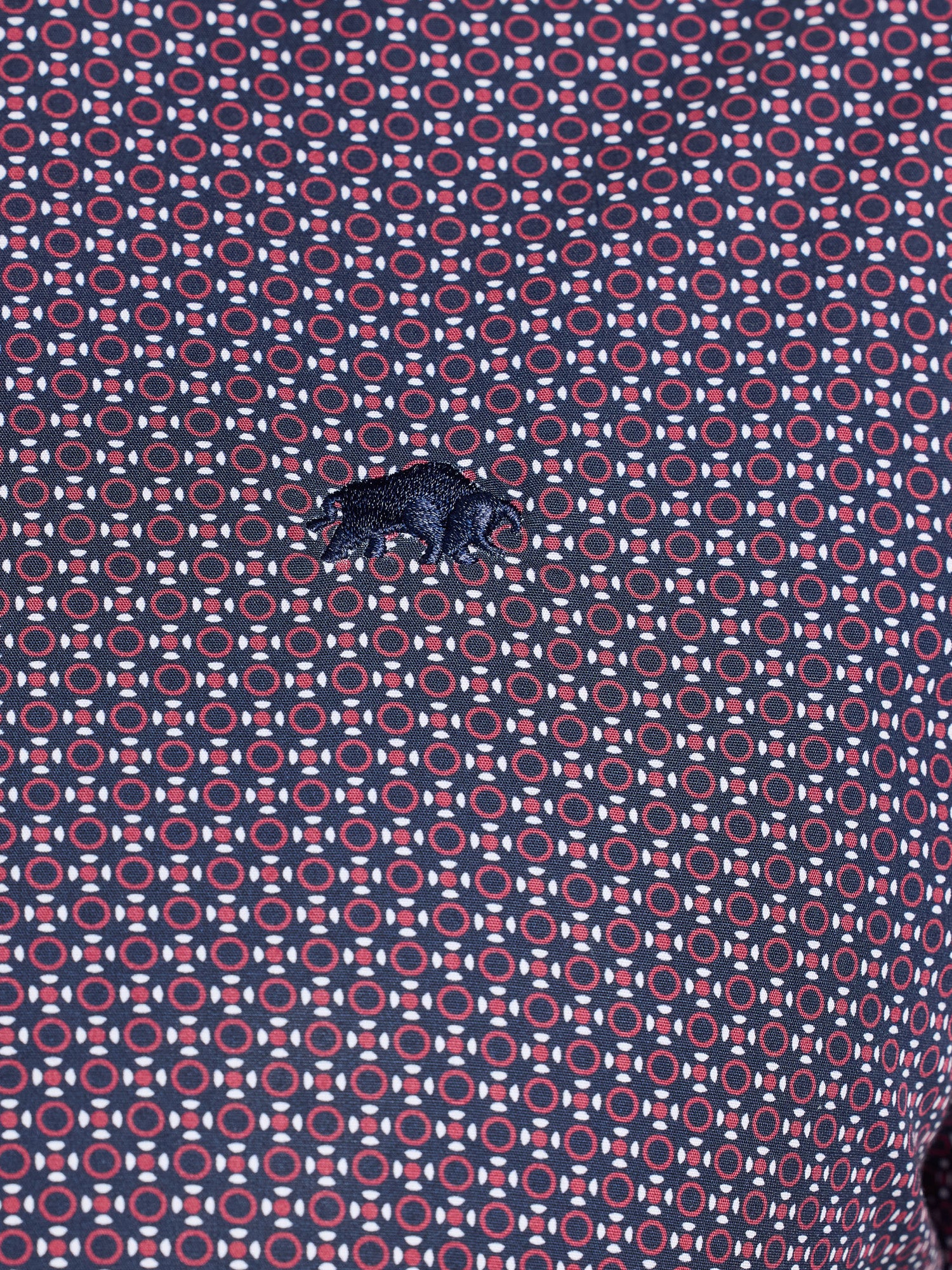 Patterned fabric with geometric design in red and blue on a purple background