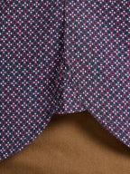 Close-up of fabric with geometric pattern on a brown background