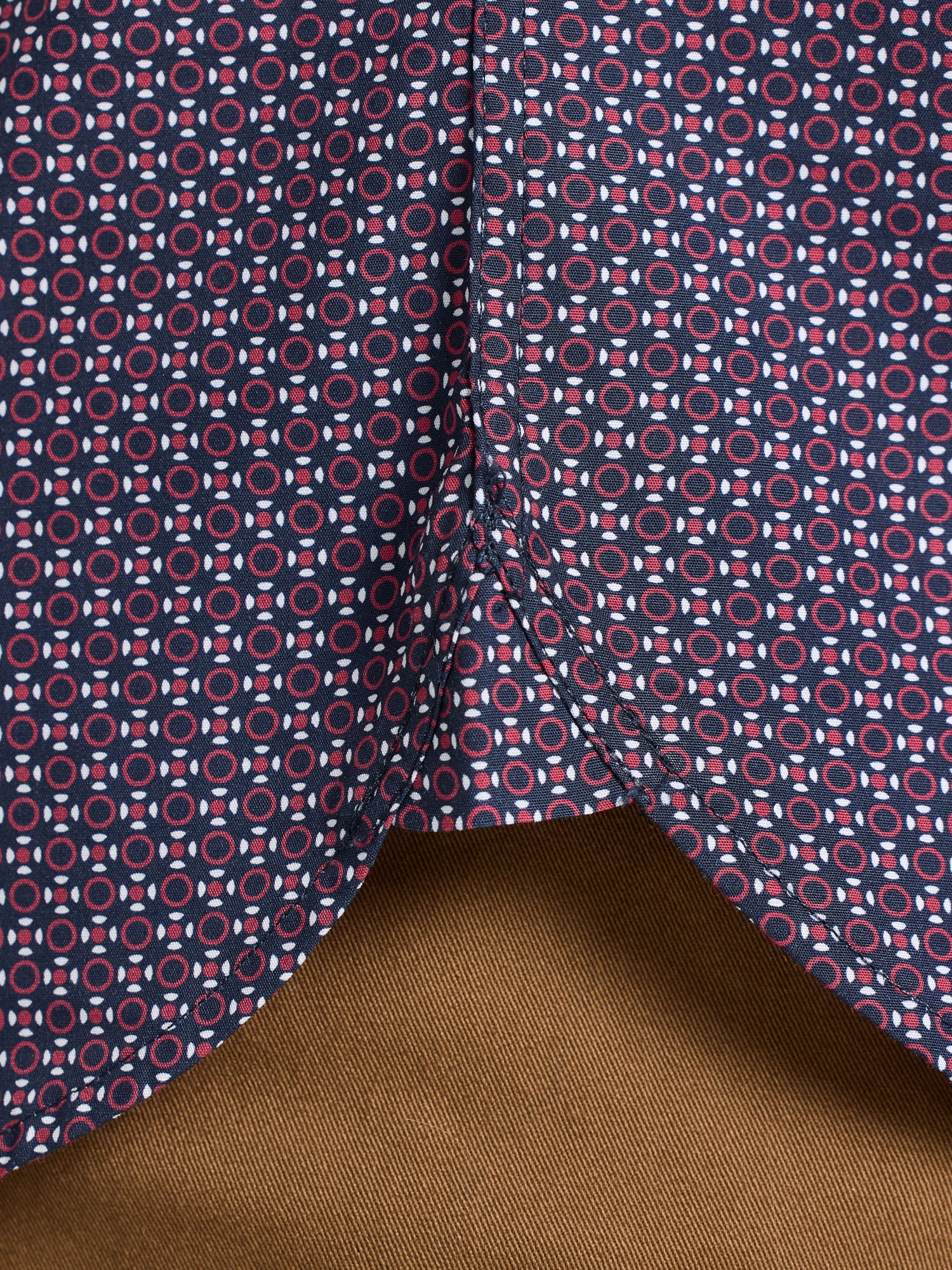 Close-up of fabric with geometric pattern on a brown background