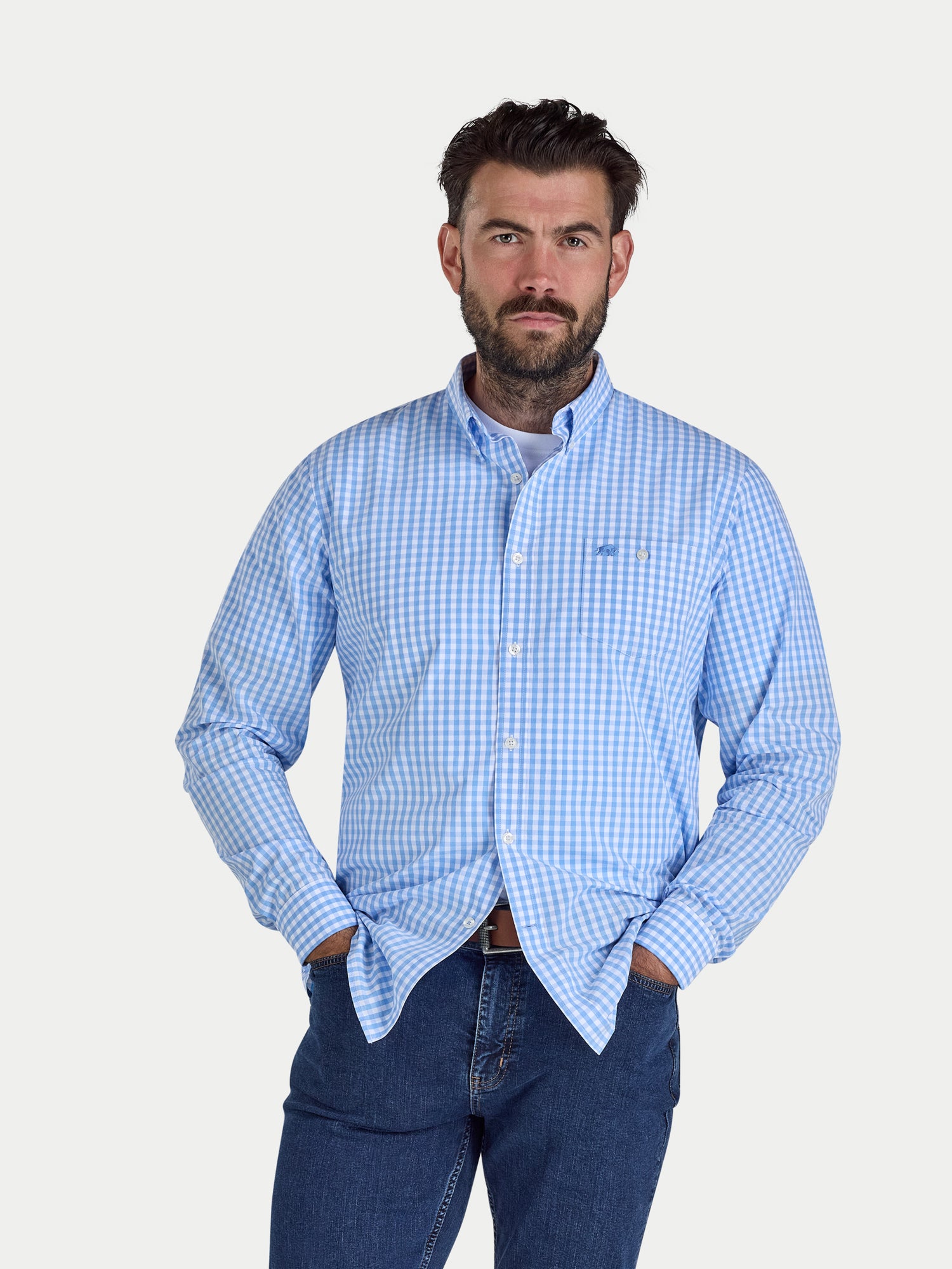 Man wearing a blue checkered shirt and jeans on a white background