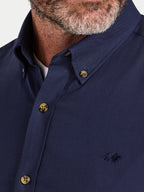 Close-up of a man wearing Raging Bull Classic Oxford Long Sleeve Shirt in Navy, collar detail, available in sizes S-6XL.