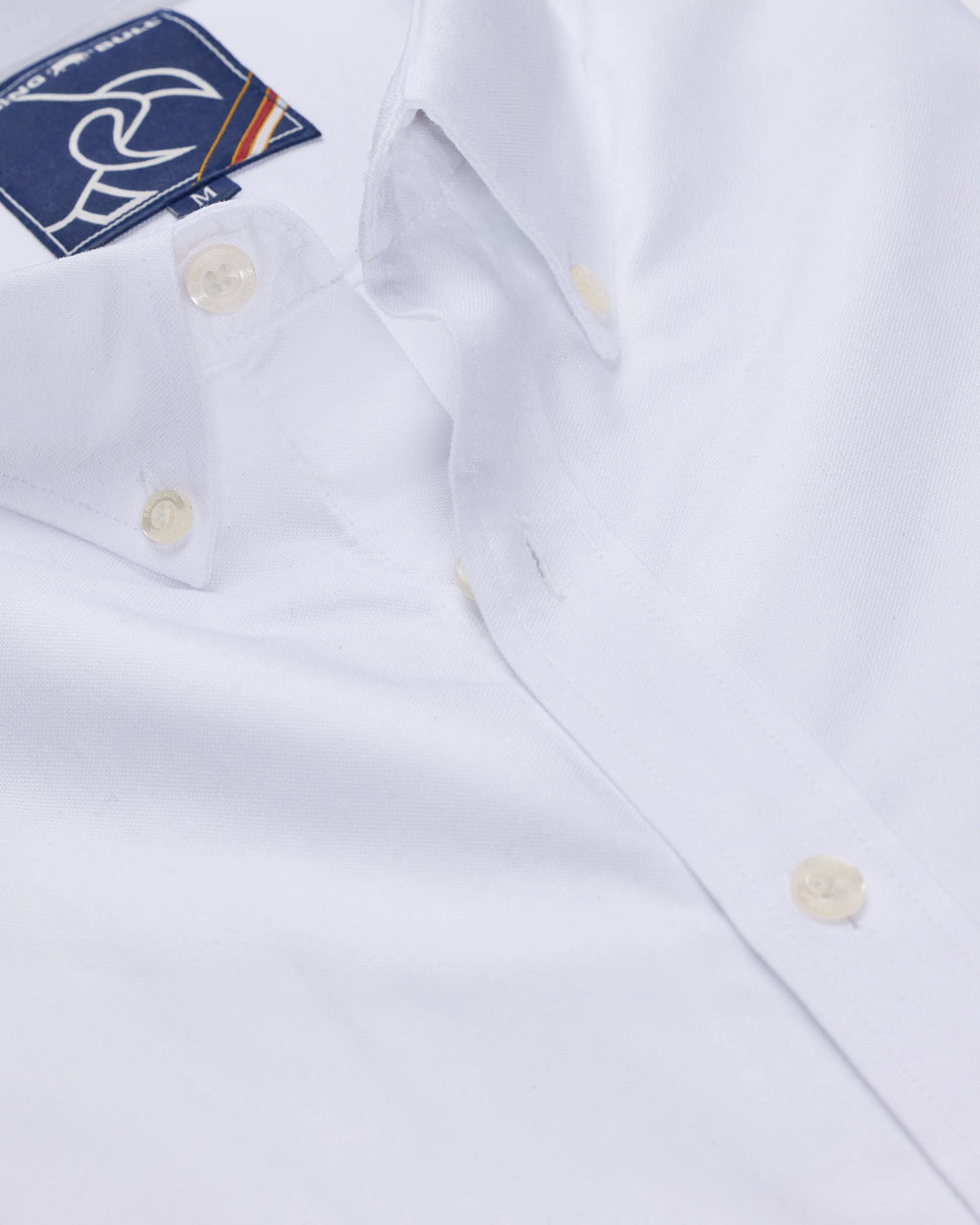 Raging Bull Classic Oxford Long Sleeve Shirt in White, available in sizes S-6XL, showing the collar, button-up design, and a small brand tag on the upper chest.