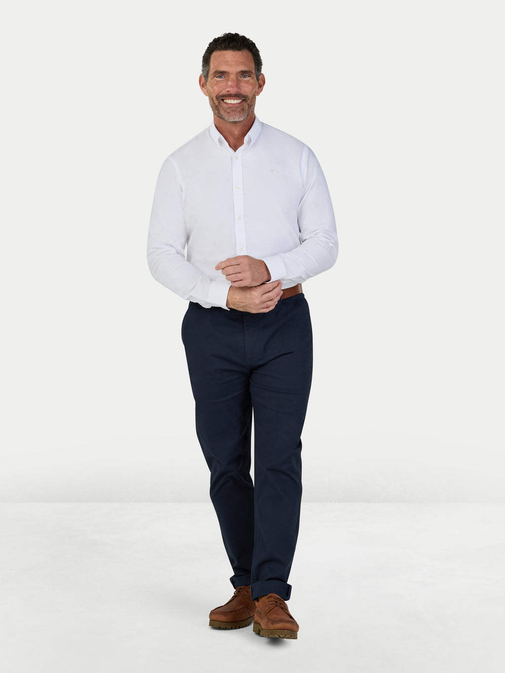 Man wearing Raging Bull Classic 2 Pack Oxford Long Sleeve Shirt in White and Classic Chino Trousers in navy, available in sizes S-6XL.