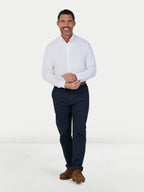 Man wearing Raging Bull Classic 2 Pack Oxford Long Sleeve Shirt in White and Classic Chino Trousers in navy, available in sizes S-6XL.