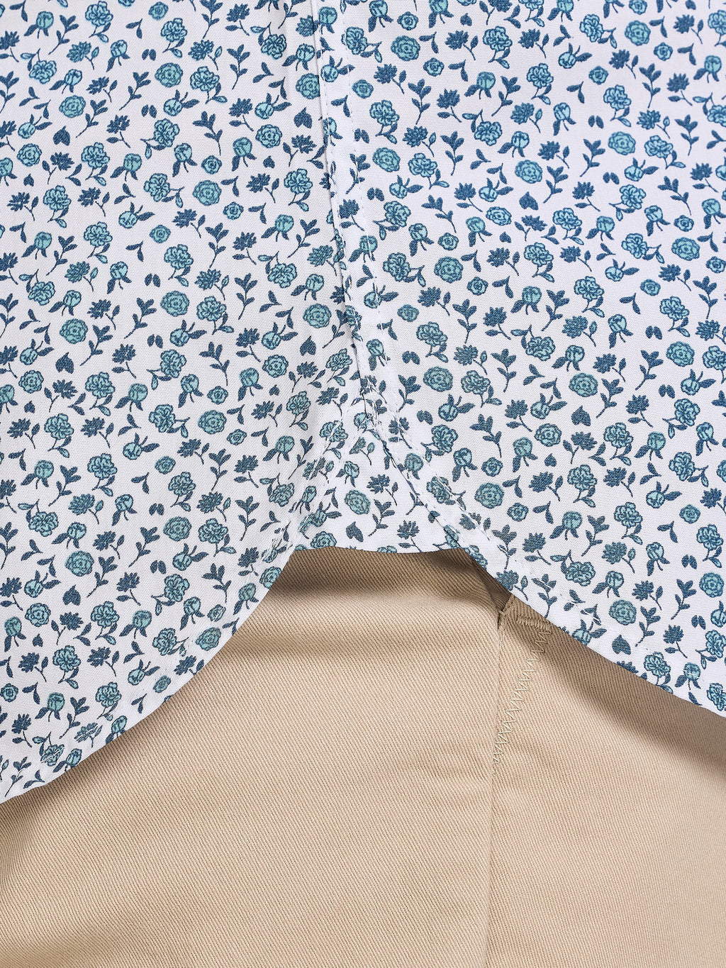 Close-up of fabric with blue floral pattern on a white background