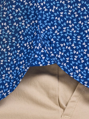 Close-up of a blue fabric with white patterns and a beige fabric corner.