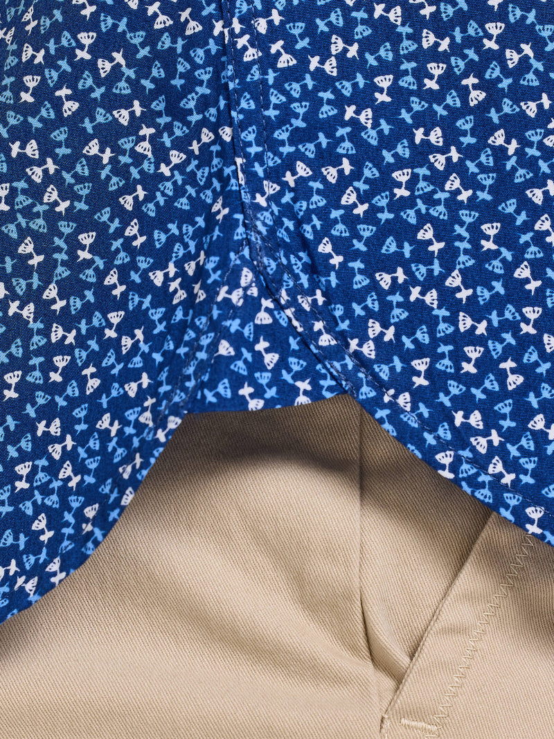Close-up of a blue fabric with white patterns and a beige fabric corner.