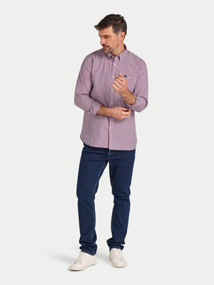 Man wearing a purple checkered shirt and blue jeans on a white background