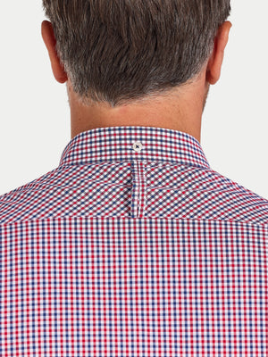 Red and blue checkered shirt worn by a person on a white background