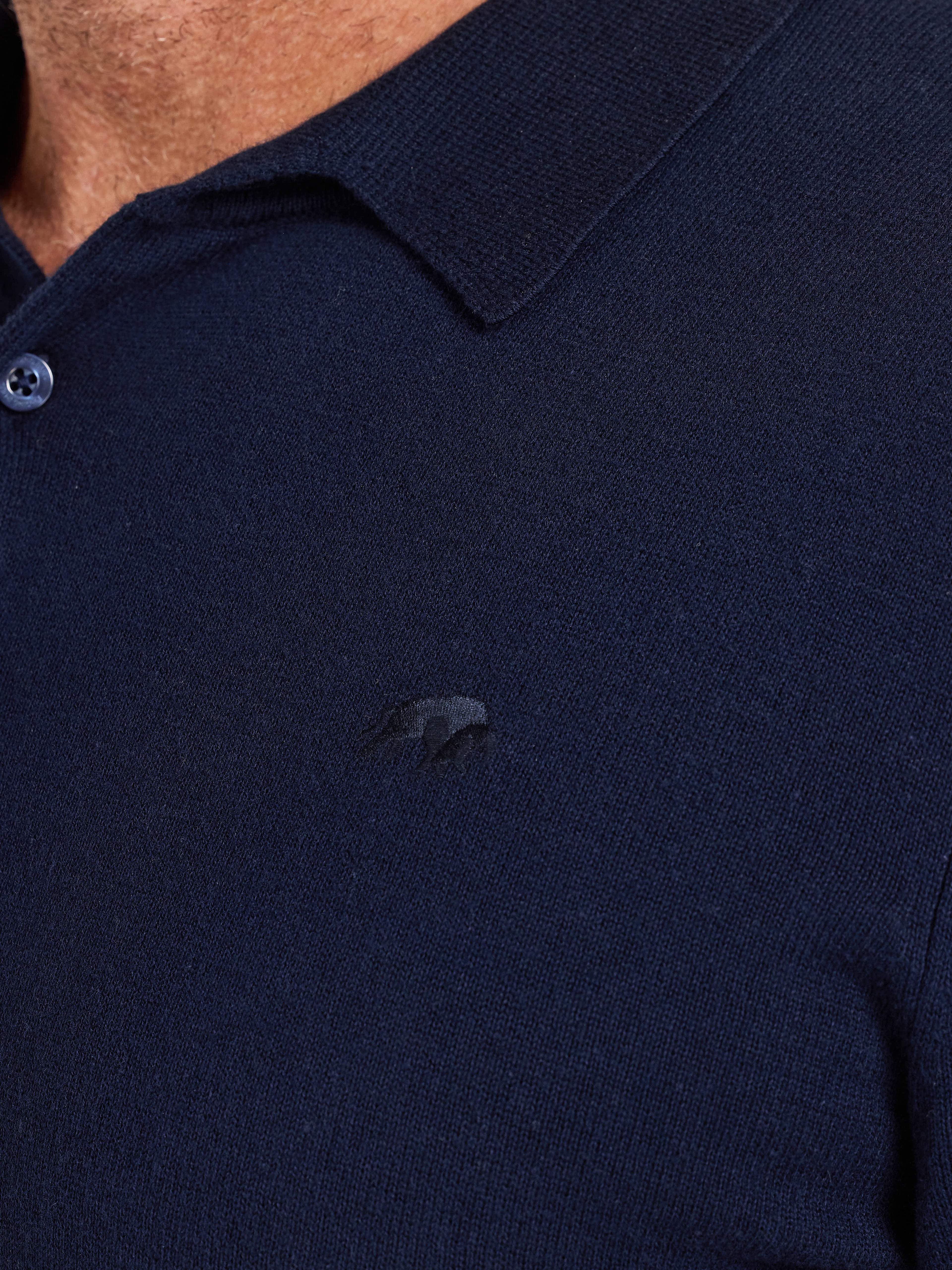 Navy blue polo shirt with a small logo on the chest