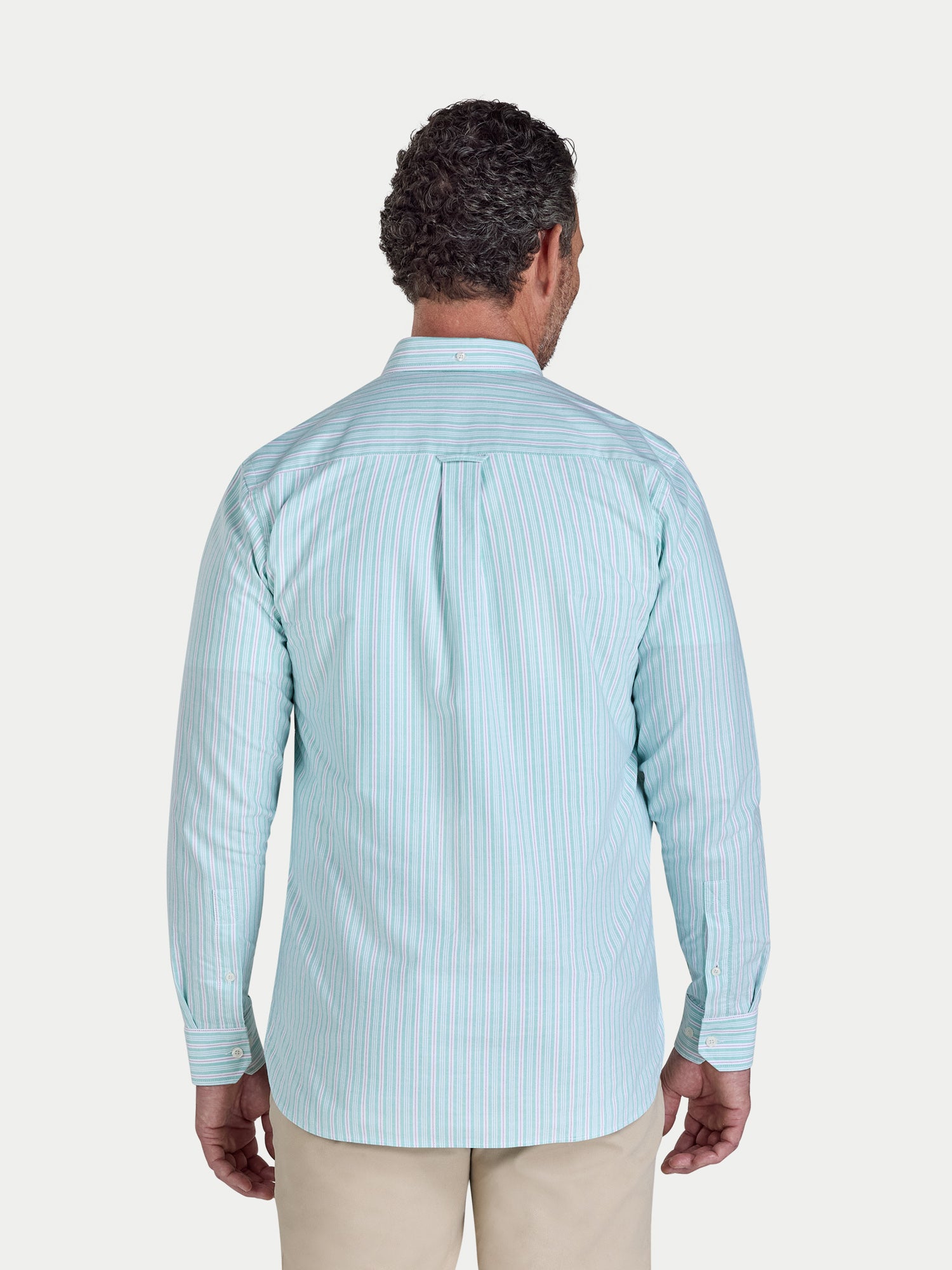 Man wearing a light blue striped shirt on a white background