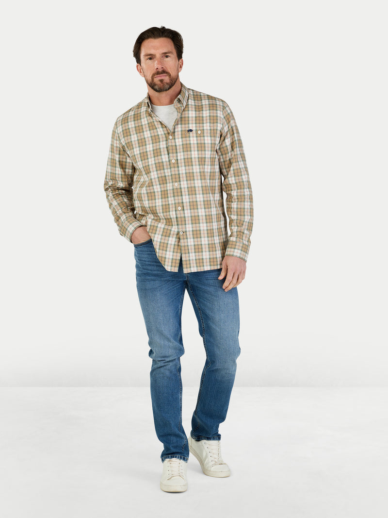Man wearing a plaid shirt and jeans on a white background