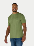 Man wearing a green t-shirt with a small black logo on a white background