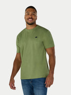 Man wearing a green t-shirt with a small black logo on a white background