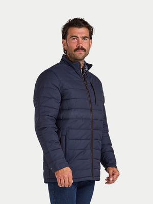 Man wearing a navy blue puffer jacket on a white background
