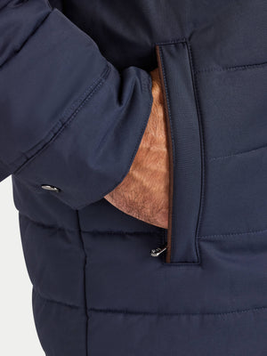 Close-up of a navy blue puffer jacket with a brown interior lining.