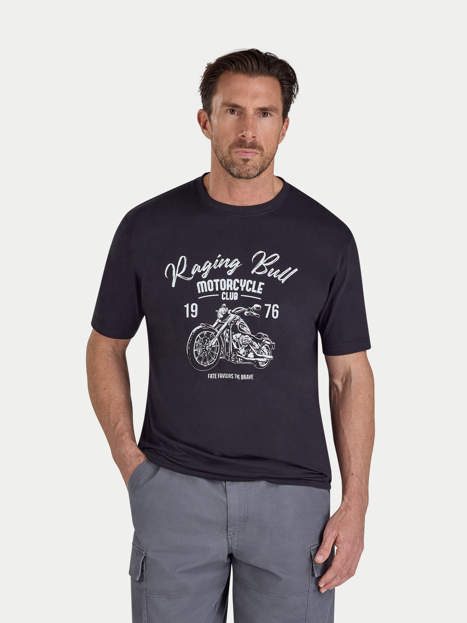 Man wearing a black t-shirt with 'Raging Bull Motorcycle Club' graphic on a white background