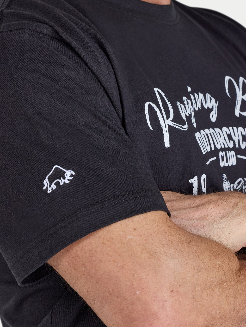 Person wearing a black t-shirt with white text and logo